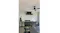 Minimalist outdoor kitchen with black rangehood, built-in grill, sink, and glass-front fridge Minimalist outdoor kitchen with black rangehood, built-in grill, sink, and glass-front fridge