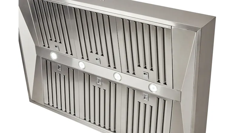 Close-up of a stainless steel rangehood with slotted filters and four built-in lights Close-up of a stainless steel rangehood with slotted filters and four built-in lights