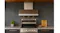 Modern outdoor kitchen with stainless steel range hood above grill, stone backsplash, wood ceiling, and countertop decor Modern outdoor kitchen with stainless steel range hood above grill, stone backsplash, wood ceiling, and countertop decor
