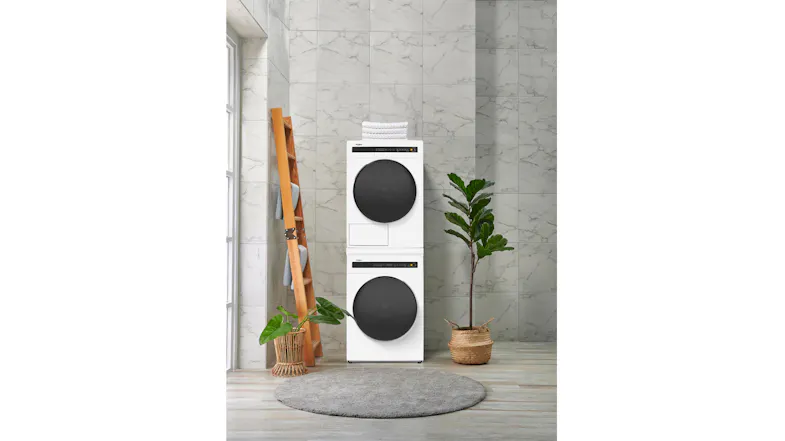 Modern laundry room showcasing a stacked washing machine and dryer Modern laundry room showcasing a stacked washing machine and dryer