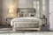 Upholstered platform bed with tufted headboard, decorative pillows, and matching nightstands in a bright room Upholstered platform bed with tufted headboard, decorative pillows, and matching nightstands in a bright room