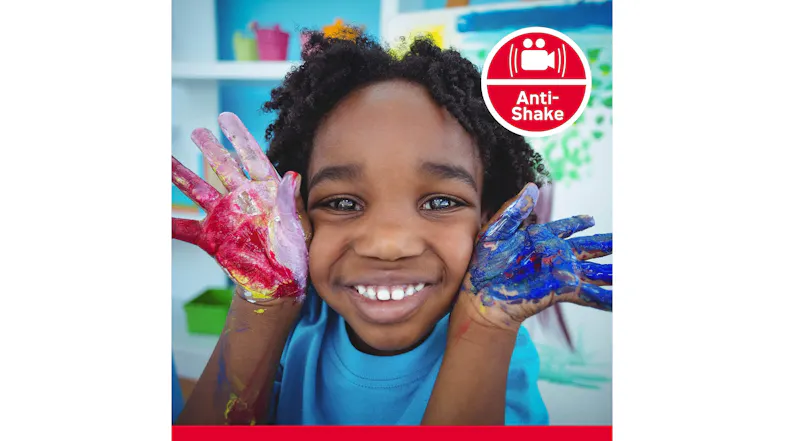 A smiling child with painted hands, highlighting an anti-shake feature A smiling child with painted hands, highlighting an anti-shake feature