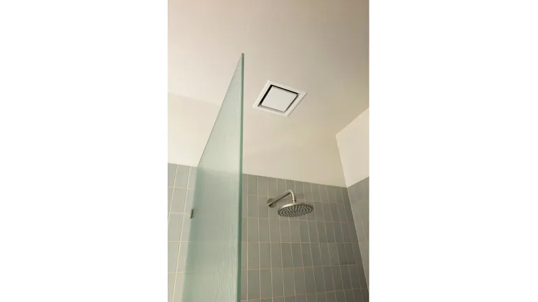 Contemporary bathroom shower with textured glass divider, blue tiles, and ceiling ventilation Contemporary bathroom shower with textured glass divider, blue tiles, and ceiling ventilation