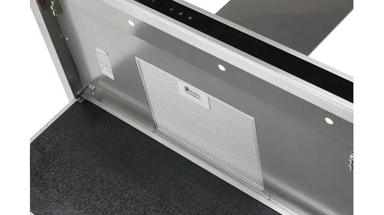 Close-up of the Schweigen rangehood interior with a mesh grease filter and two lights illuminating the open panel Close-up of the Schweigen rangehood interior with a mesh grease filter and two lights illuminating the open panel