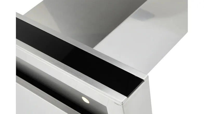 A close-up view of the stainless-steel rangehood edge showing the black glass control strip and built-in LED light underneath A close-up view of the stainless-steel rangehood edge showing the black glass control strip and built-in LED light underneath