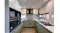 Compact modern kitchen with ample storage, a double sink, and minimalist cabinetry design Compact modern kitchen with ample storage, a double sink, and minimalist cabinetry design