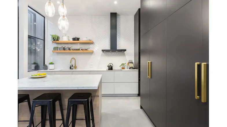 Modern kitchen with white cabinets, marble island, black stools, and sleek black rangehood Modern kitchen with white cabinets, marble island, black stools, and sleek black rangehood