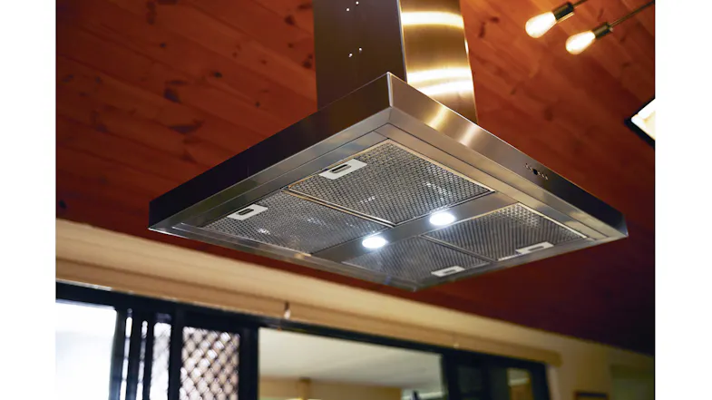 Ceiling-mounted rangehood detail with metal filters and lights in a contemporary kitchen Ceiling-mounted rangehood detail with metal filters and lights in a contemporary kitchen