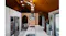 Rustic modern kitchen with brick arch wall, island cooktop, and stainless steel rangehood centrepiece Rustic modern kitchen with brick arch wall, island cooktop, and stainless steel rangehood centrepiece