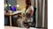 Side view of the woman sitting with the strapped heating wrap Side view of the woman sitting with the strapped heating wrap