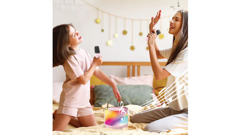 Two young girls singing at home, highlighting the product's portability Two young girls singing at home, highlighting the product's portability