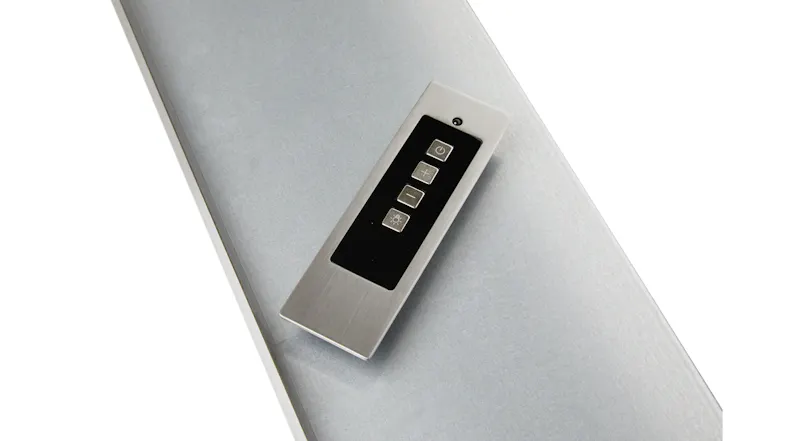 Detailed view of the slim remote control with brushed metal finish and black touch panel Detailed view of the slim remote control with brushed metal finish and black touch panel