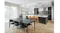 Contemporary kitchen and dining with a large island, a black dining table, wood floors and a stainless-steel rangehood centrepiece Contemporary kitchen and dining with a large island, a black dining table, wood floors and a stainless-steel rangehood centrepiece