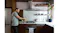 A man is standing at a kitchen counter preparing a drink beside a stovetop under a stainless steel rangehood A man is standing at a kitchen counter preparing a drink beside a stovetop under a stainless steel rangehood