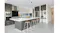 Modern kitchen with large island bench, stainless steel rangehood, dark cabinetry and integrated oven appliances Modern kitchen with large island bench, stainless steel rangehood, dark cabinetry and integrated oven appliances