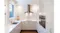 Bright white kitchen with stainless steel rangehood, herringbone tile splashback, double sink and sleek cabinetry Bright white kitchen with stainless steel rangehood, herringbone tile splashback, double sink and sleek cabinetry