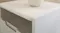 Close-up of a white modern nightstand top surface showing clean edges Close-up of a white modern nightstand top surface showing clean edges