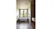 Bright bathroom with a freestanding tub, window, tiled walls, and a square ceiling vent above Bright bathroom with a freestanding tub, window, tiled walls, and a square ceiling vent above