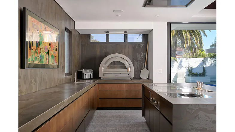 Modern kitchen with built-in pizza oven and Schweigen ceiling cassette rangehood, sleek cabinetry, stone benchtops and open layout Modern kitchen with built-in pizza oven and Schweigen ceiling cassette rangehood, sleek cabinetry, stone benchtops and open layout