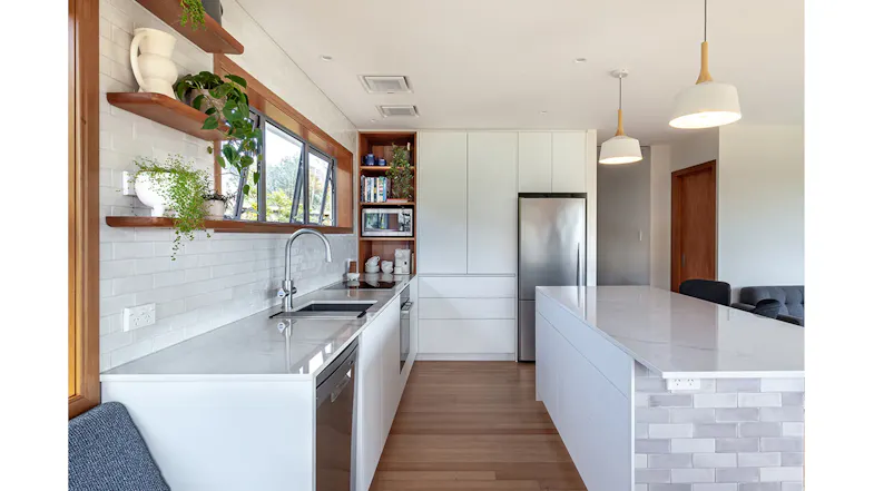 Modern kitchen interior with white cabinets, timber accents and ceiling cassette rangehood modules, sleek open plan layout Modern kitchen interior with white cabinets, timber accents and ceiling cassette rangehood modules, sleek open plan layout