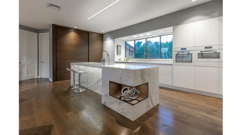 Modern kitchen with island bench and timber detail, featuring ceiling cassette rangehood modules in a sleek minimalist space Modern kitchen with island bench and timber detail, featuring ceiling cassette rangehood modules in a sleek minimalist space