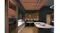 Contemporary kitchen interior with ceiling cassette rangehood modules, wood panel ceiling, built-in ovens and round dining nook Contemporary kitchen interior with ceiling cassette rangehood modules, wood panel ceiling, built-in ovens and round dining nook