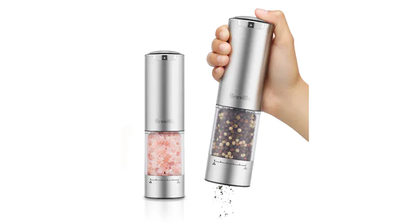 A hand operating the salt and pepper mill A hand operating the salt and pepper mill