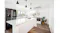 Bright white kitchen with an island, pendant lights, large windows, a stainless steel fridge, and an indoor plant Bright white kitchen with an island, pendant lights, large windows, a stainless steel fridge, and an indoor plant