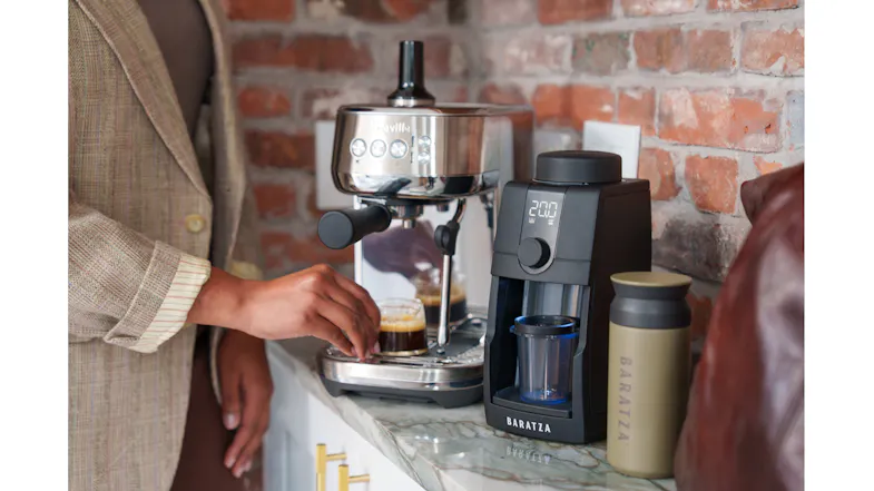 Countertop scene with a person making espresso with the grinder Countertop scene with a person making espresso with the grinder