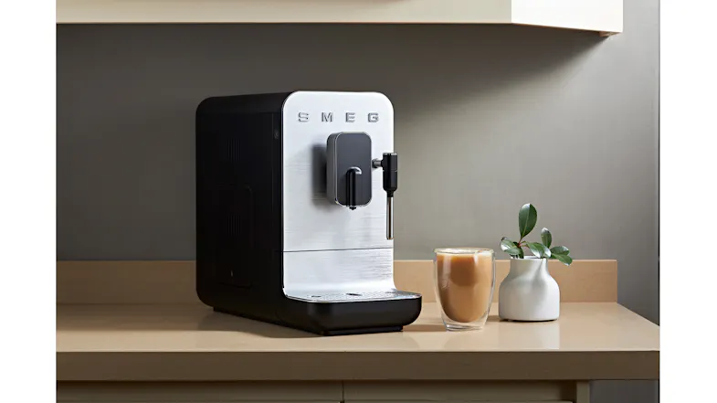 Countertop scene showcasing the Smeg appliance with a tall milky coffee drink Countertop scene showcasing the Smeg appliance with a tall milky coffee drink