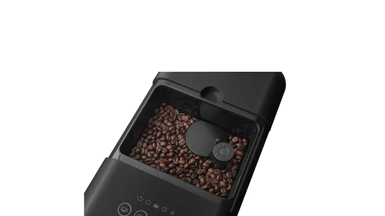 Top-down view of the Smeg unit showcasing a hopper filled with coffee beans Top-down view of the Smeg unit showcasing a hopper filled with coffee beans