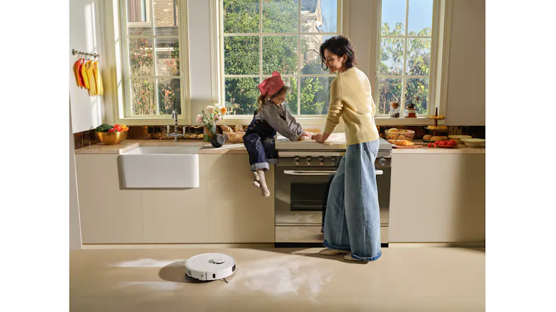 Bright kitchen highlighting a robot vacuum on a tiled floor Bright kitchen highlighting a robot vacuum on a tiled floor