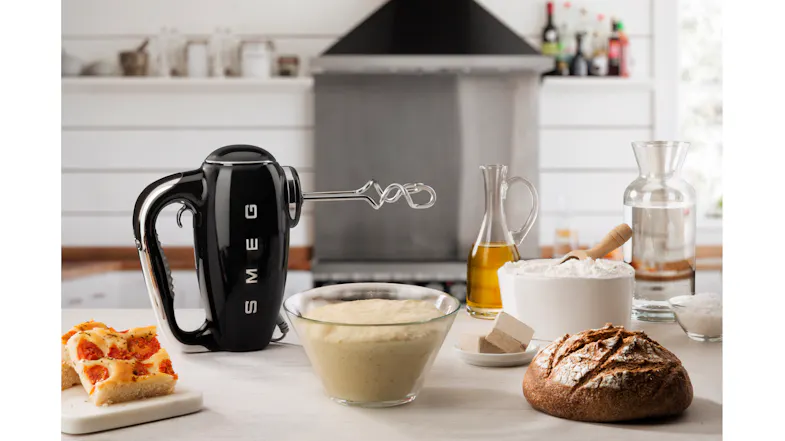 Modern kitchen scene showing a hand mixer standing beside bread dough Modern kitchen scene showing a hand mixer standing beside bread dough