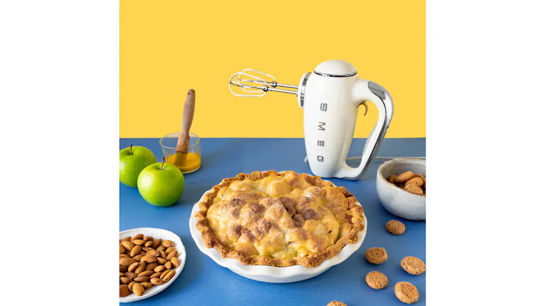 Modern kitchen scene showing a hand mixer standing beside bread and nuts Modern kitchen scene showing a hand mixer standing beside bread and nuts