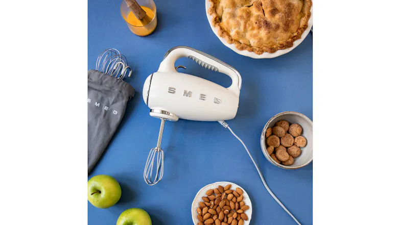 A blue kitchen counter showing freshly baked bread next to a hand mixer A blue kitchen counter showing freshly baked bread next to a hand mixer