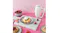 Pink counter with a Smeg hand mixer, highlighting fresh strawberry tarts Pink counter with a Smeg hand mixer, highlighting fresh strawberry tarts