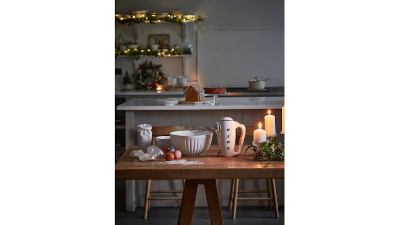 Cosy kitchen setting with a hand mixer and baking ingredients Cosy kitchen setting with a hand mixer and baking ingredients