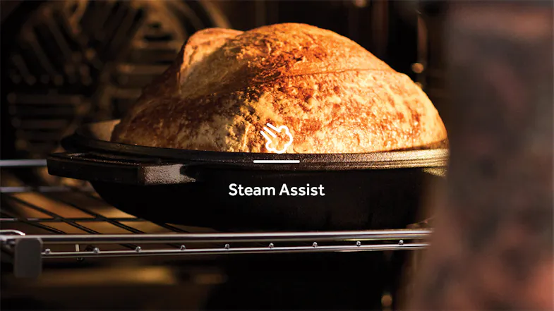 Freshly baked bread inside the oven, highlighting the steam assist icon Freshly baked bread inside the oven, highlighting the steam assist icon