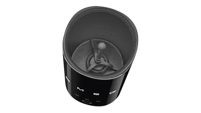 Top interior view of the frother with lid removed, revealing the stainless steel lining and small whisk attachment Top interior view of the frother with lid removed, revealing the stainless steel lining and small whisk attachment