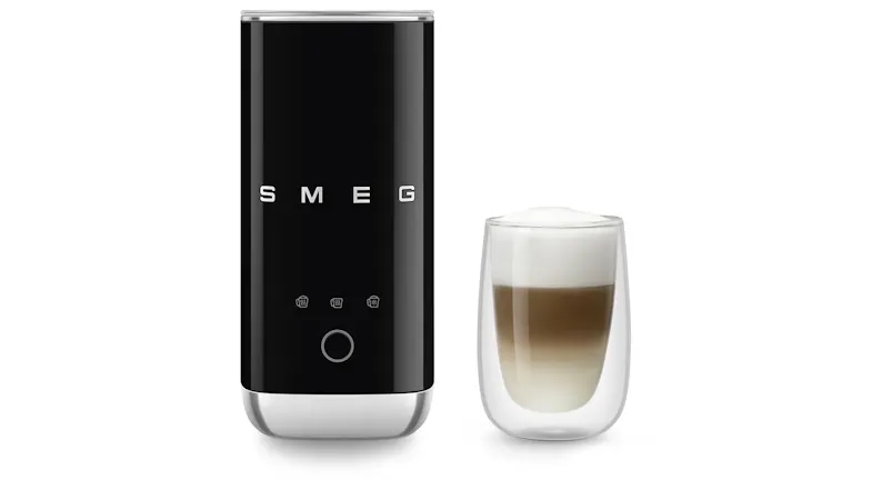 Front view of the black mini frother beside a glass of layered milk coffee, highlighting its use Front view of the black mini frother beside a glass of layered milk coffee, highlighting its use
