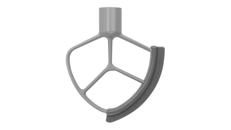 Close-up of a flat beater attachment with a flexible edge in grey, designed to scrape the sides of the mixing bowl Close-up of a flat beater attachment with a flexible edge in grey, designed to scrape the sides of the mixing bowl