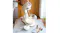 Lifestyle kitchen scene featuring the cream Smeg mixer in use with a wire whisk, mixing white cream Lifestyle kitchen scene featuring the cream Smeg mixer in use with a wire whisk, mixing white cream