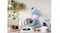 Stand mixer with whisk attachment and stainless steel bowl on a countertop against a white brick wall Stand mixer with whisk attachment and stainless steel bowl on a countertop against a white brick wall