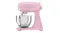 Side view of the glossy pink Smeg 4.8L stand mixer with a stainless steel bowl attached Side view of the glossy pink Smeg 4.8L stand mixer with a stainless steel bowl attached