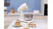 Smeg stand mixer with whisk attachment and stainless steel bowl on a marble countertop Smeg stand mixer with whisk attachment and stainless steel bowl on a marble countertop