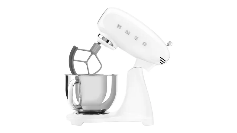 Side view of the glossy white Smeg stand mixer with tilt head raised and flat beater attachment Side view of the glossy white Smeg stand mixer with tilt head raised and flat beater attachment
