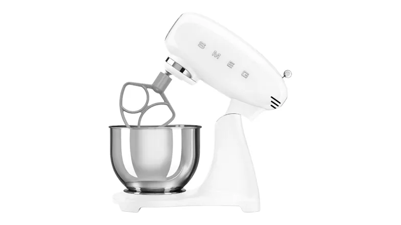 Side angle of the Smeg mixer with tilt head raised, fitted with a flex-edge or alternative beater attachment Side angle of the Smeg mixer with tilt head raised, fitted with a flex-edge or alternative beater attachment