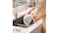 Person rinsing a pet fountain part in a sink, demonstrating easy maintenance design with visible, fully washable components Person rinsing a pet fountain part in a sink, demonstrating easy maintenance design with visible, fully washable components