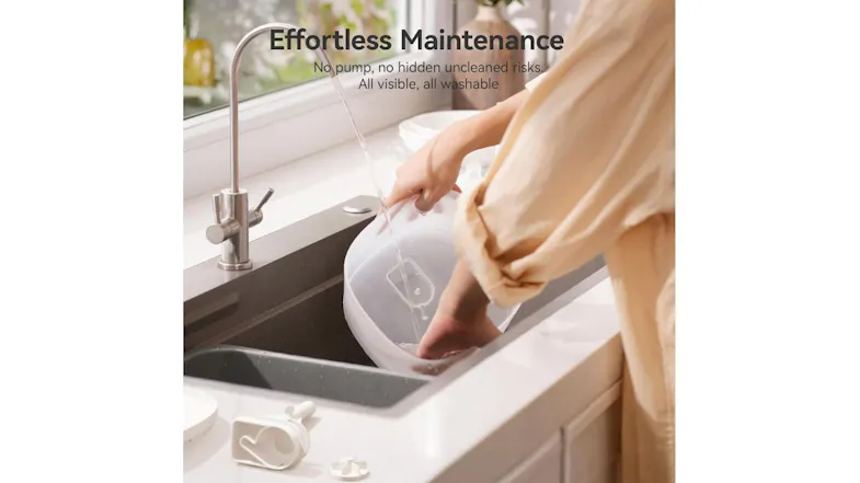 Person rinsing a pet fountain part in a sink, demonstrating easy maintenance design with visible, fully washable components Person rinsing a pet fountain part in a sink, demonstrating easy maintenance design with visible, fully washable components