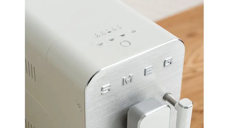 Close-up view of the coffee machine, highlighting the control buttons and the Smeg logo Close-up view of the coffee machine, highlighting the control buttons and the Smeg logo